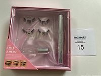 Front view of sealed Glamnetic Lash Extension Kit showing contents and label claims: 2 pairs of lashes, bond remover, bond, grab applicator.