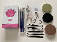 Full lot including box for heated eyelash curler, two metal eyelash curlers, three lash applicators, three lash wands, three travel lash cases in gold, black, and rose gold