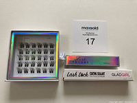 Lash Theory Lash Bond adhesive and Glad Girl Lash Lock coating sealant boxes next to the closed lash cluster box.