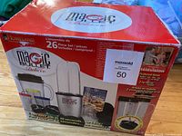 Box exterior showing Magic Bullet Deluxe branding and 26-piece set information.