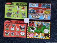 All four puzzles together showing their size and subjects on a dark carpet background.