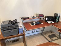 View of multiple devices positioned on desks and shelves including printers, calculators, and electronic accessories.