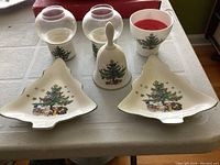 Group photo showing two candle holders with glass globes, one ceramic candle holder without globe, Christmas bell, and two Christmas tree-shaped candy dishes all decorated with a Christmas tree motif.