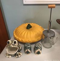 View of all items including the pumpkin pie dish, glass nut crusher, frog figurine, and salt and pepper shakers.
