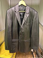 Front view of black Alfani leather blazer jacket on hanger, showing notch lapels, three buttons, and front pockets.