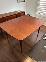 Full view of rectangular teak table top and tapered legs