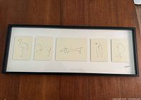 Full view of framed artwork containing five separate lithograph prints of Picasso animal line drawings, installed on white matboard and enclosed in black IKEA Olunda frame.
