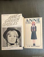 Front cover of a small book showing a black-and-white photograph of an actress as Anne from the musical or film adaptation with the title 'Triple Treat Anne of Green Gables'