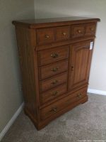Angled front view of dresser showing drawer and cabinet arrangement and proportion.