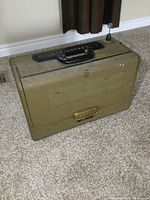 Closed view of olive drab military case with carry handle