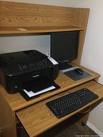 Photo showing Canon MX532 printer placed on a wooden desk next to a black keyboard and a 17-inch Acer monitor in the background.