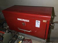 Front view of red metal tool box, closed, showing 'Tool Centre' branding.