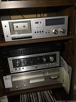 Full stack of four components in wood shelving: Realistic cassette deck, Pioneer equalizer, Marantz amplifier, Marantz tuner