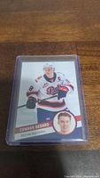 Front side of 2023 Hot Shot Connor Bedard Regina Pats hockey card in protective sleeve showing player image and design.
