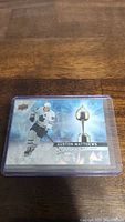 Front of the Auston Matthews Hart Attack insert card showing holographic image with player in white Toronto Maple Leafs uniform and Hart Trophy graphic.