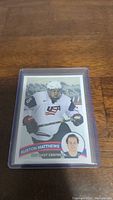 Front of Auston Matthews rookie hockey card showing player in USA hockey uniform with name and position displayed.