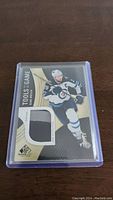 Front of the Blake Wheeler hockey trading card showing the player in action and the embedded jersey patch.