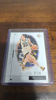 Front of Caitlin Clark rookie basketball card showing her in action for the Iowa Hawkeyes, card in protective sleeve.