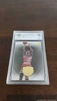 Front view of the encapsulated Michael Jordan 2008-09 Upper Deck MJ Legacy Collection Gold basketball card graded BCCG 10 in plastic case.