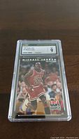 1982 sealed basketball card featuring Michael Jordan in Chicago Bulls uniform, encased in plastic with CSG 9 grade.