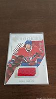 Photo of Noah Juulsen rookie jersey hockey card, numbered 388 of 399, showing embedded red fabric patch and player in Canadiens uniform.