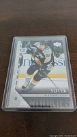 Front of Ryan Suter YoungGuns Rookie hockey card showing player in Nashville Predators uniform skating on ice.