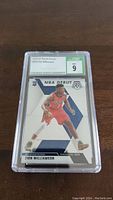 Photo of 2019-20 Panini Mosaic Zion Williamson rookie card graded CSG 9, showing player in red New Orleans Pelicans uniform with NBA debut design.