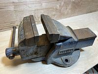 Side angle showing the vise's jaws, handle, mounting base, and the brand plate 'Record'