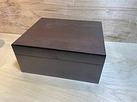 Closed humidor box showing smooth dark wood finish and rectangular shape