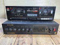 Front view of the stereo double cassette deck on top of the Bogen Gold Seal Series audio control unit on wooden surface.