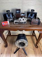 View of all cameras, slide reader, bulb box, and ring light on wooden table