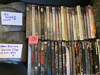 Photo showing 24 open DVDs mostly in horror genre with spine titles visible, and a note indicating all sealed DVDs are separate.