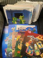 Stacked plastic display boards showing Talespin, Looney Tunes and other Happy Meal promotional signage