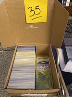Box top view with over 500 Pokémon cards stacked and sleeved