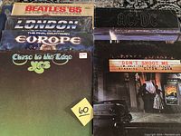 Photo showing Beatles '65, London, Europe, Yes, AC/DC, and Elton John album covers stacked.