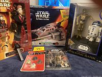 Full lot view showing Ultimate Hair Queen Amidala doll, Star Wars Power of the Force Rebel Snowspeeder box, Return of the Jedi magnets, Artoo-Detoo diecast metal keychain, and Star Wars Electronic Talking Bank.
