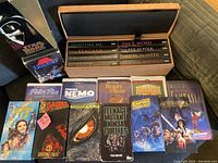 Photo showing the Star Wars box set, Peter Pan, Finding Nemo, Beauty and the Beast, Bambi, Fantasia, Return of the Jedi, Empire Strikes Back, Teenage Mutant Ninja Turtles, Godzilla, X-Men, and Wizard of Oz VHS tapes.