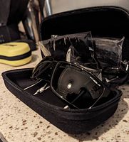 Arnette Hazard sunglasses in black textured case showing front lenses and frame