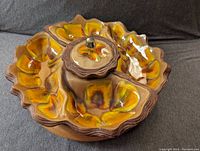Ceramic server with bright glazed wavy sections on a wooden Lazy Susan base