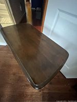 Top surface view of the solid wood end table showing the smooth, polished finish with rounded edges.