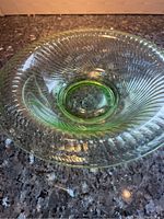 Top view of the round green tinted glass bowl showing ribbed texture and center base.