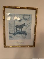 Full view of framed artwork showing the zebra print, map background, and gold bamboo-style frame.