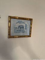 Full view of the framed elephant print hung on a wall, showing size and frame style.