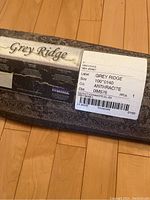 Close-up image of Grey Ridge brand label showing rug size (100x140), color (anthracite), and model info