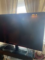 Front view of the Samsung TV showing the screen and the Samsung logo on the bottom bezel.