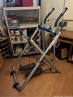 Full view of the Tony Little Gazelle Sprint Master exercise machine showing silver metal frame, black pedals, and foam hand grips.