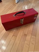 Closed red metal toolbox with black handle and Mastercraft branding.