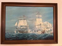 Full view of framed oil painting showing two sailing ships on ocean under cloudy sky.