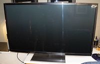 Front view of the Panasonic Viera 55-inch plasma TV turned off, showing black bezel and stand.