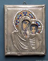 Front view showing the entire icon with metal plating, embossed details of Mother of God and child Jesus, and colorful enamel on halos.